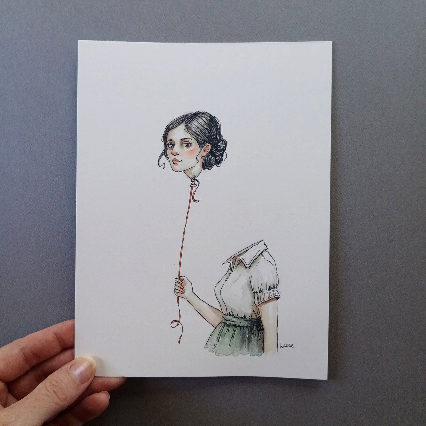 Illustration of a woman holding a ballon of her own head. 